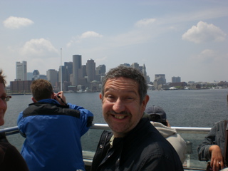 Head of BT Research Labs, grinning on boat, Boston in background